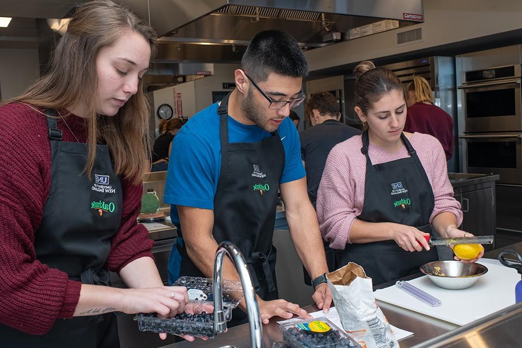 Three nutrition students preparing food